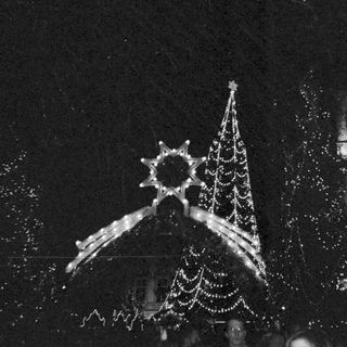Lit Christmas decorations at nighttime event.