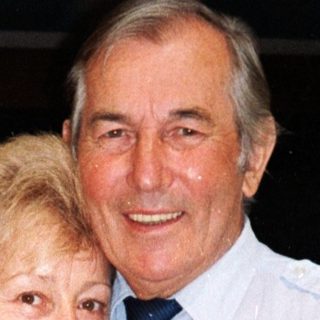 Happy elderly couple posing indoors together.
