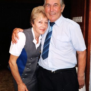 Happy elderly couple posing indoors together.