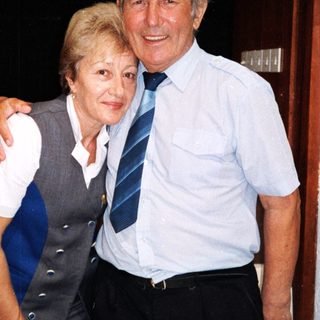 Happy elderly couple posing indoors together.