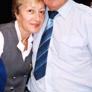 Happy elderly couple posing indoors together.