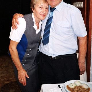 Happy elderly couple posing indoors together.