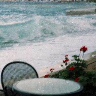 Coastal waves crashing near rocky cliffs.
