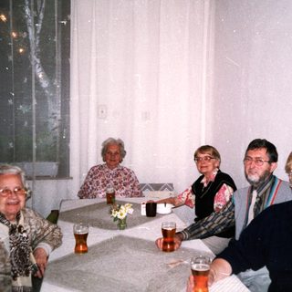 Group of five people enjoying drinks indoors.
