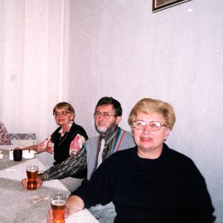 Group of five people enjoying drinks indoors.