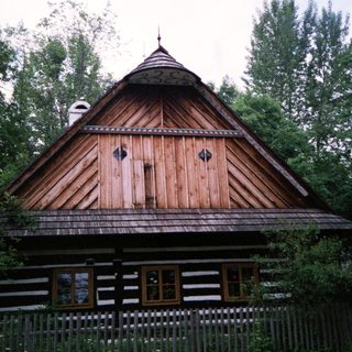 Traditional wooden house with steep gabled roof.