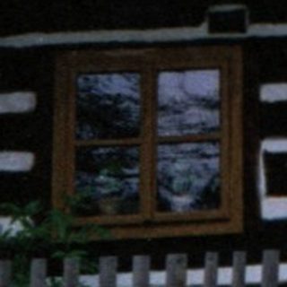 Traditional wooden house with steep gabled roof.