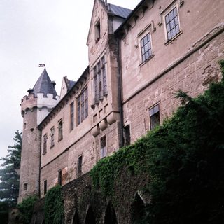 Medieval-style castle with ivy-covered stone walls.