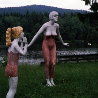 Three life-sized sculptures in outdoor setting.