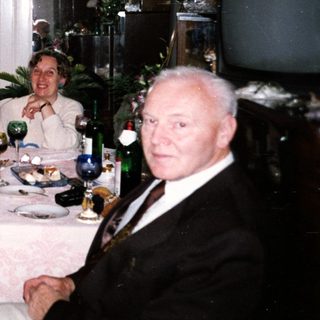 Four adults gathered indoors for a festive meal.