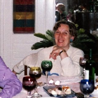 Four adults gathered indoors for a festive meal.