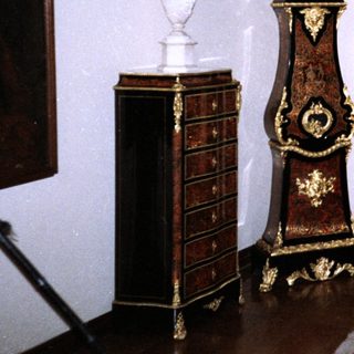 Elegant 18th-century French-style furniture ensemble with clock.