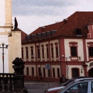 Baroque-style church with twin red domes.