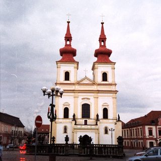 Baroque-style church with twin red domes.
