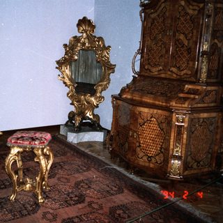 Elegant antique room with ornate gold furniture and intricate designs.