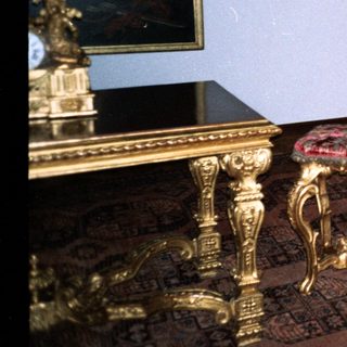 Elegant antique room with ornate gold furniture and intricate designs.
