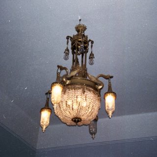 Ornate vintage chandelier with candle-style bulbs.