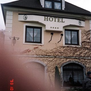 Charming vintage hotel with ivy-covered facade.