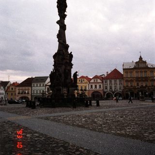 Baroque column monument in historic European town square.