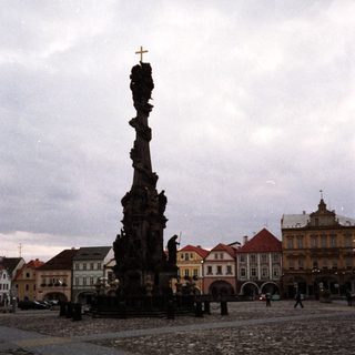 Baroque column monument in historic European town square.