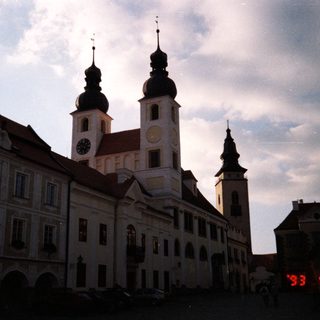 Historic European town square with church towers.