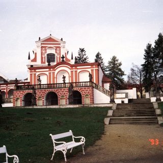 Baroque-style building with red-and-white facade.