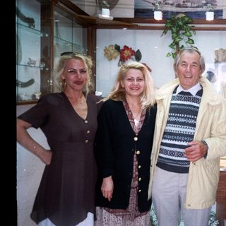 Four people posing together indoors near decorative items.