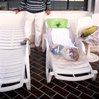 Man relaxing on patio by ocean view.