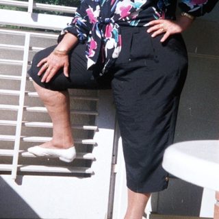 Woman posing confidently on brick stairs.
