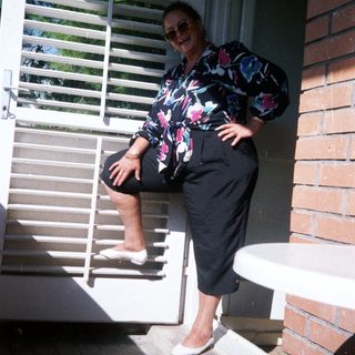 Woman posing confidently on brick stairs.