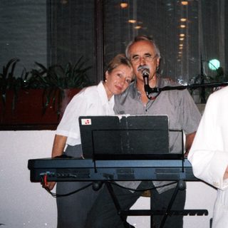 Three people performing live music indoors.