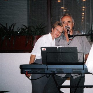 Three people performing live music indoors.