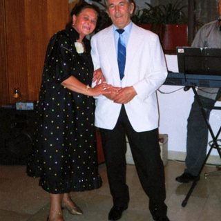 Formal event with man receiving award from woman.