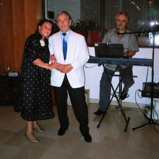 Formal event with man receiving award from woman.