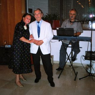 Formal event with man receiving award from woman.