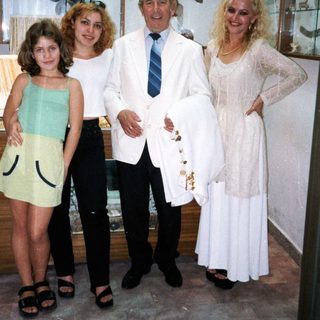 Family posing indoors at a bridal shop.