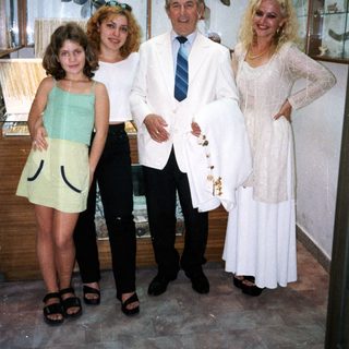 Family posing indoors at a bridal shop.