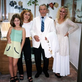 Family posing indoors at a bridal shop.