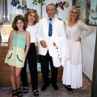 Family posing indoors at a bridal shop.