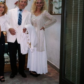 Family posing in formal attire at wedding.
