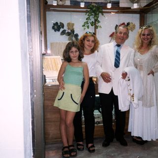 Family posing in formal attire at wedding.