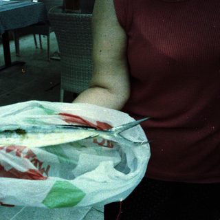 Fresh fish served on a paper-lined plate.