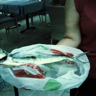 Fresh fish served on a paper-lined plate.