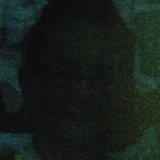 Blurred reflection of people in a room.