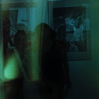 Blurred reflection of people in a room.