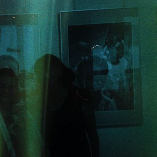 Blurred reflection of people in a room.