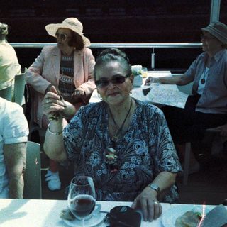 Group of elderly people posing indoors at a table.