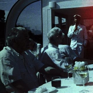 Group dining on a cruise ship deck.