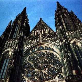 Gothic cathedral facade with intricate stained glass rose window.