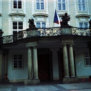 Elegant classical building with flagpole and columns.